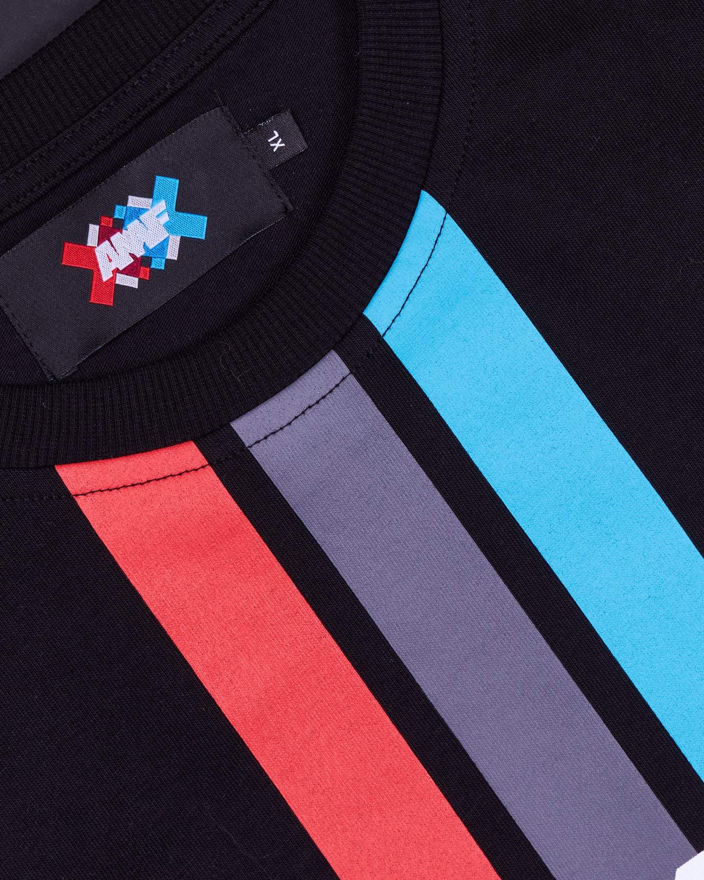 Close-up of the ribbed collar of a black T-shirt, with a black neck label showing AMF in white over red, blue and grey crosses and the size XL, above red, grey and blue stripes running diagonally down the front.