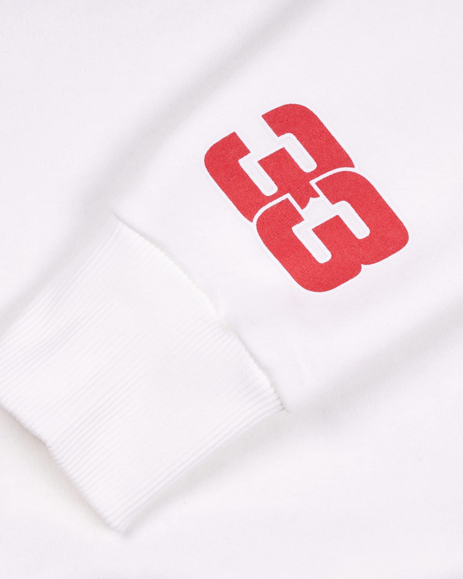 Close-up of a white sleeve with a large red 33 above its ribbed cuff.