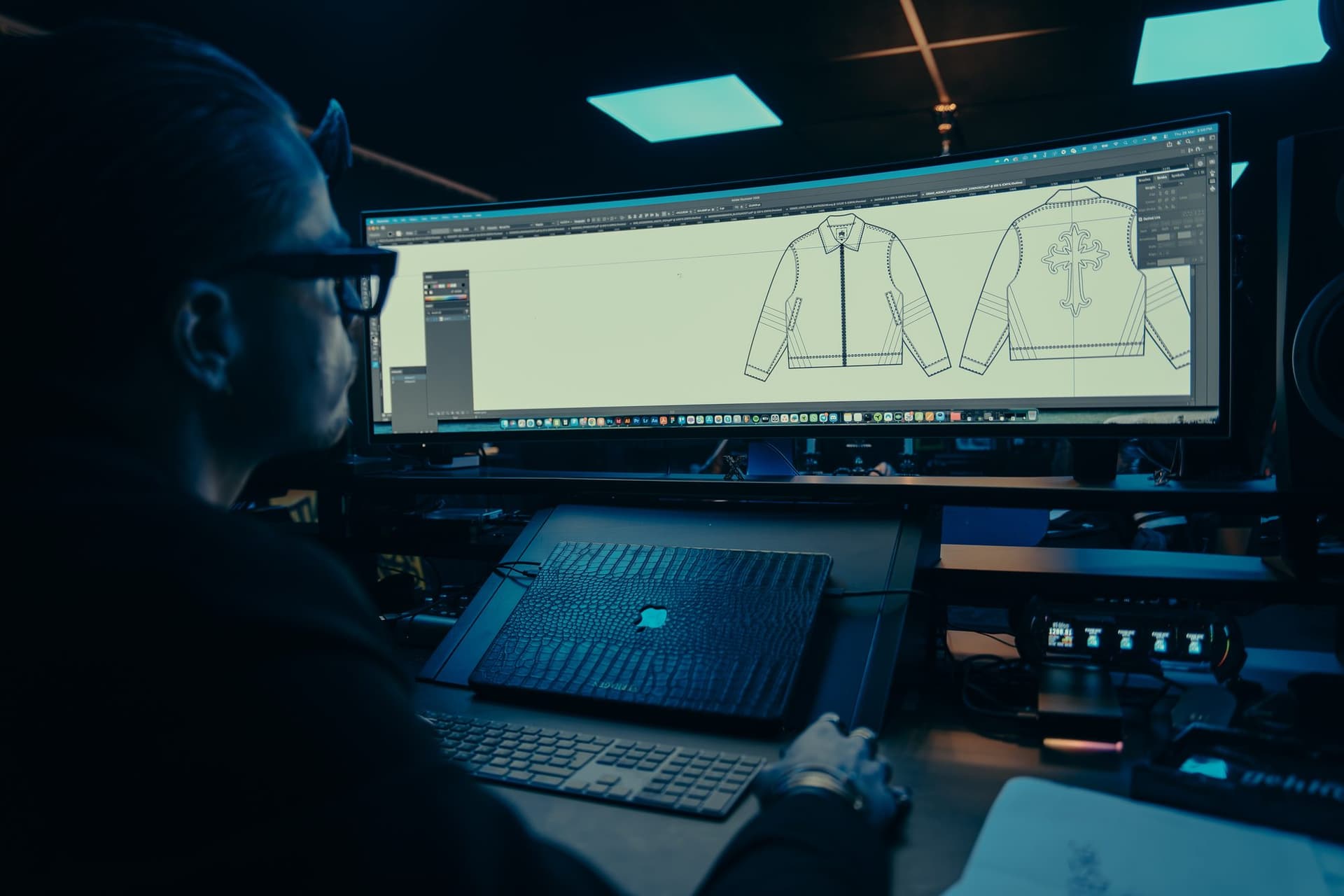 Designer drawing a jacket tech pack on screen in the GEKKO Agency studio in Rotterdam