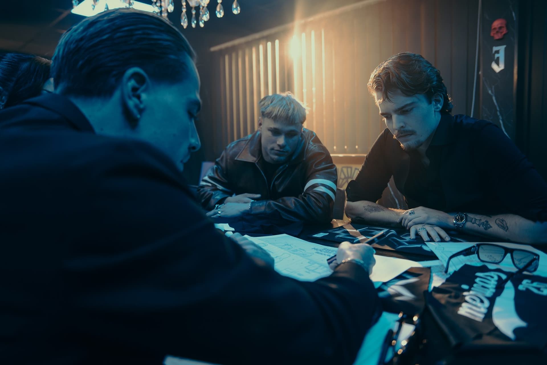 The GEKKO team reviewing garment designs and samples at a table in the studio